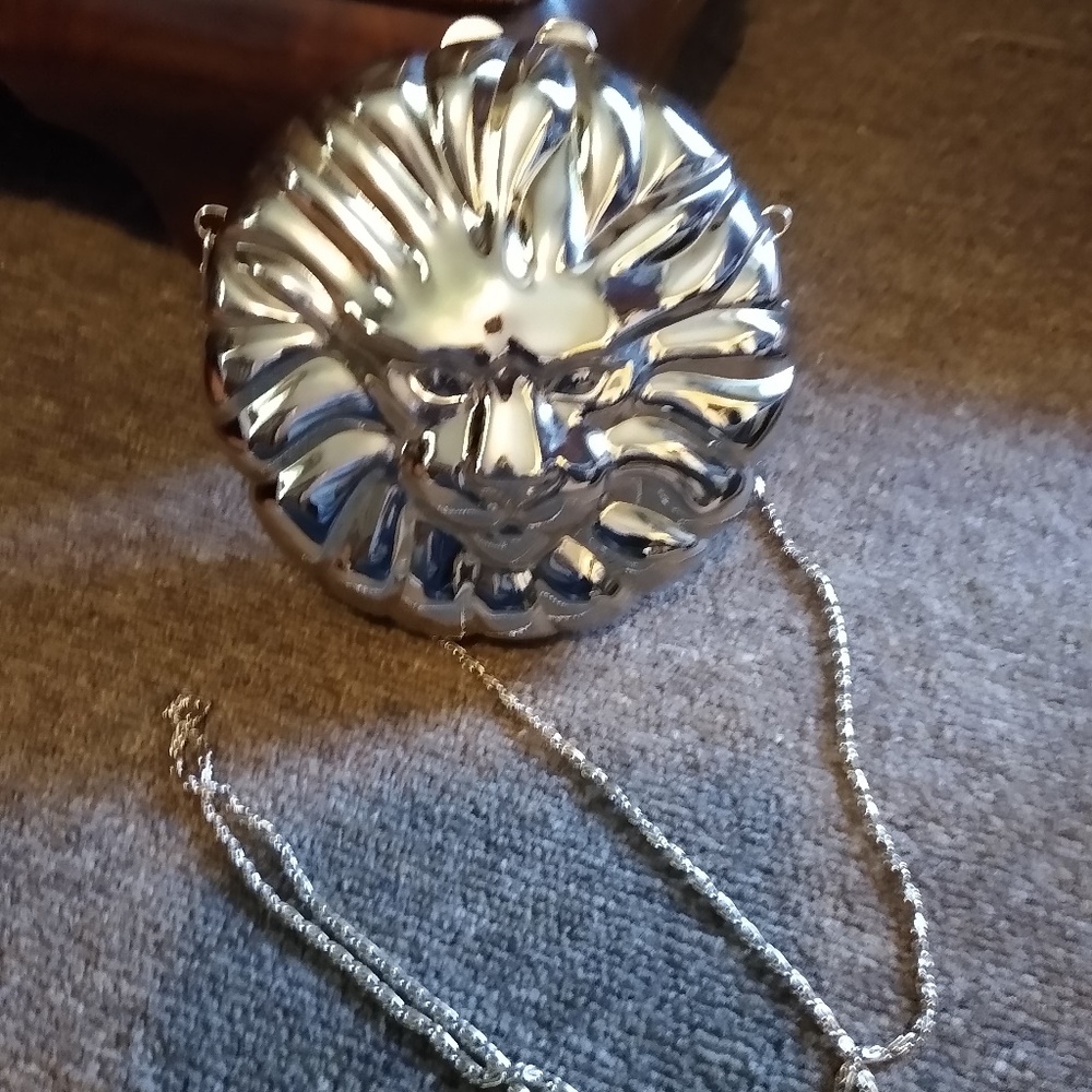 Silver metal mini cross body purse.
